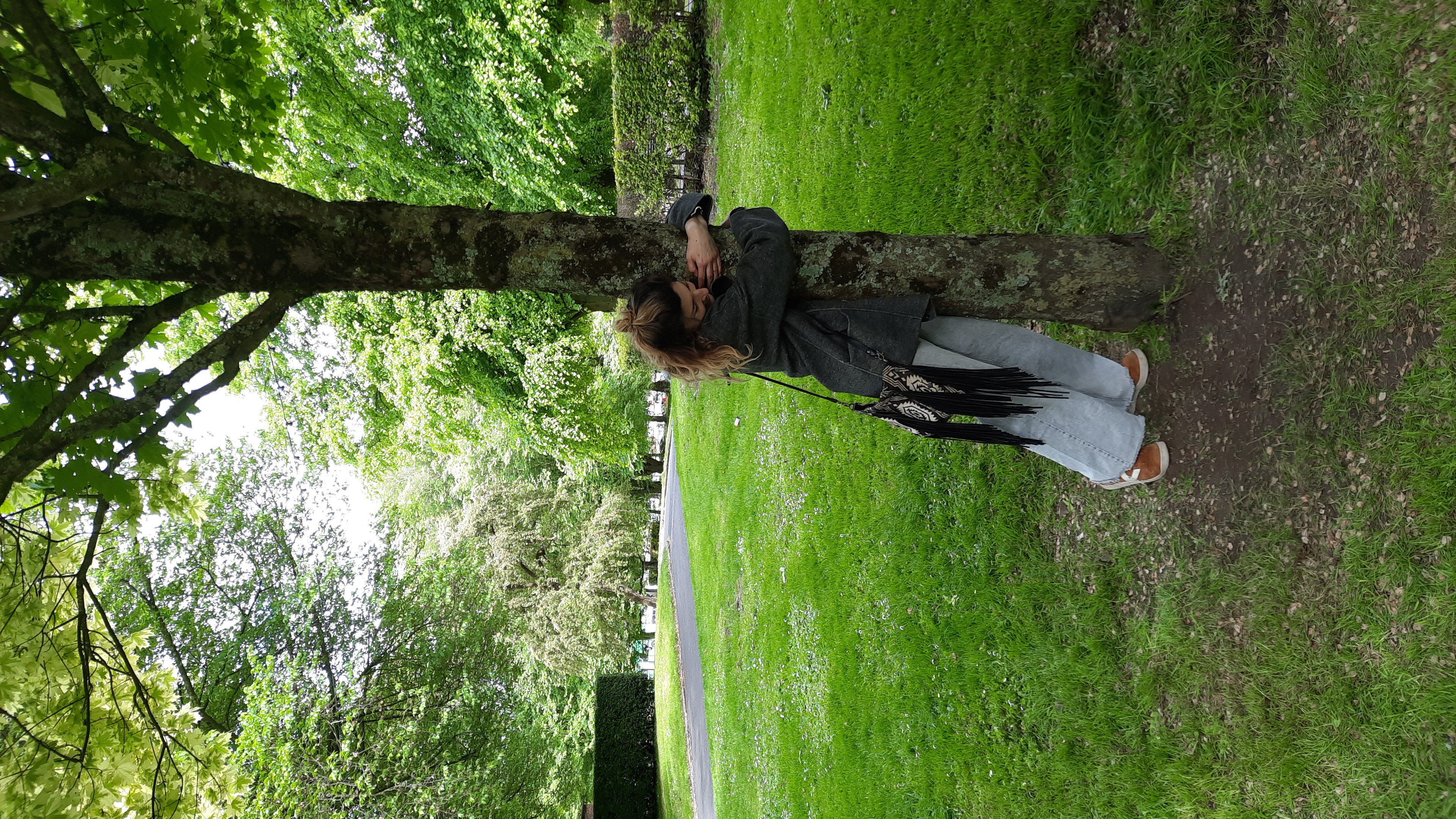 Close-up, hand resting on bark near a contact transducer, outdoor daylight. Future Limerick Festival 2022.