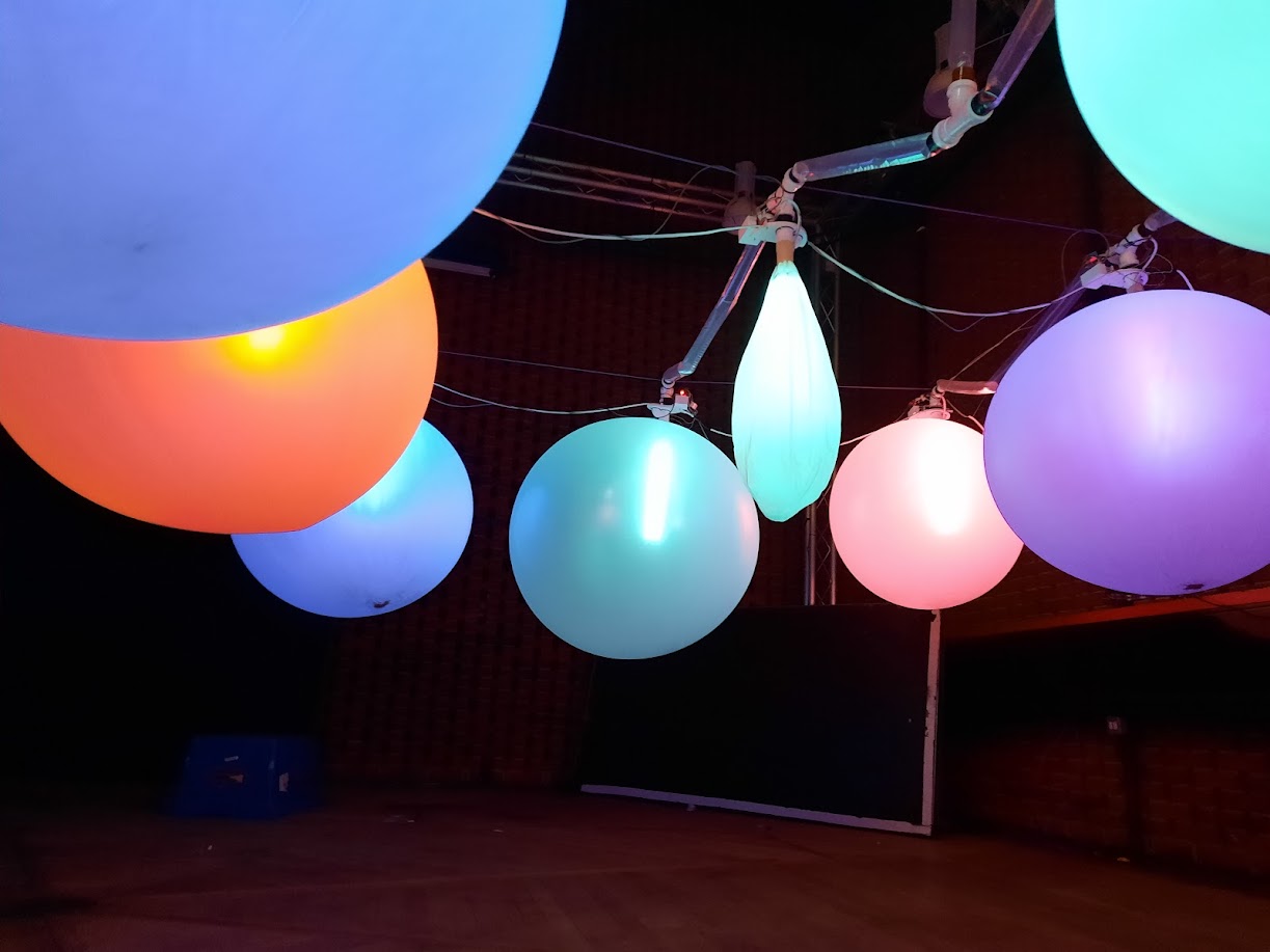 Detail, balloon surface shimmering with RGB light, colour at peak inflation.